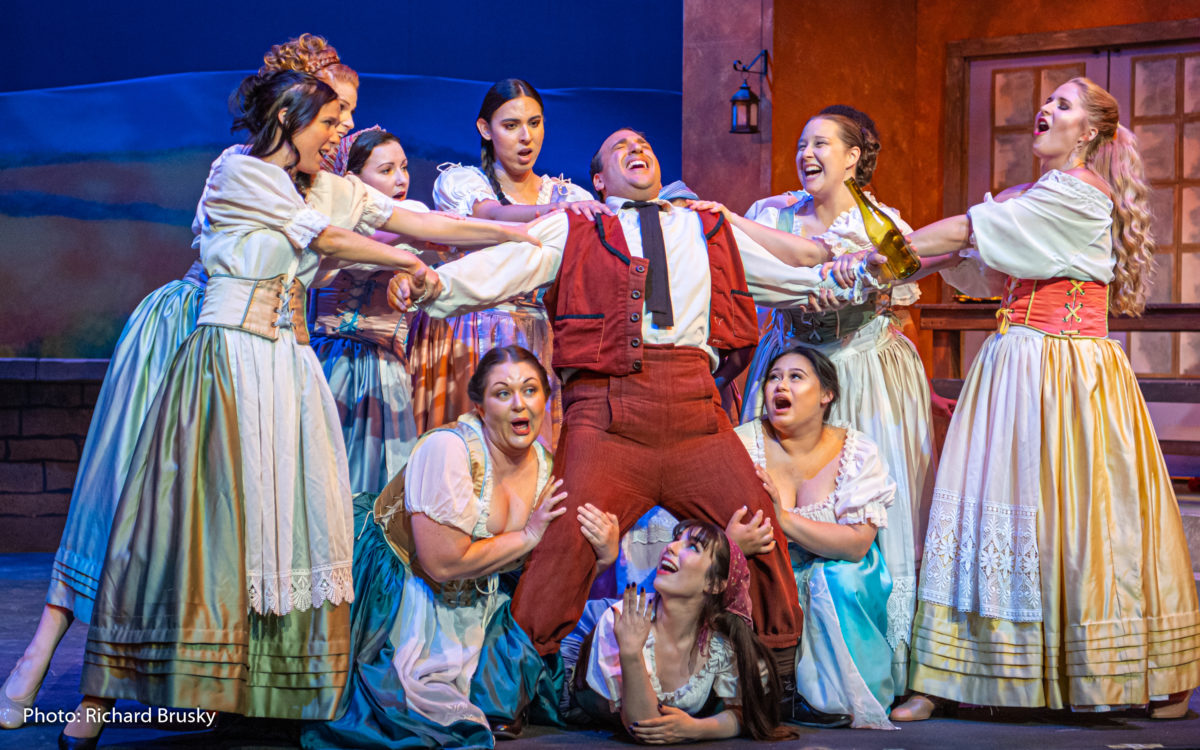 Nemorino in Donizetti's "Elixir of Love," drunk and surrounded by adoring women.