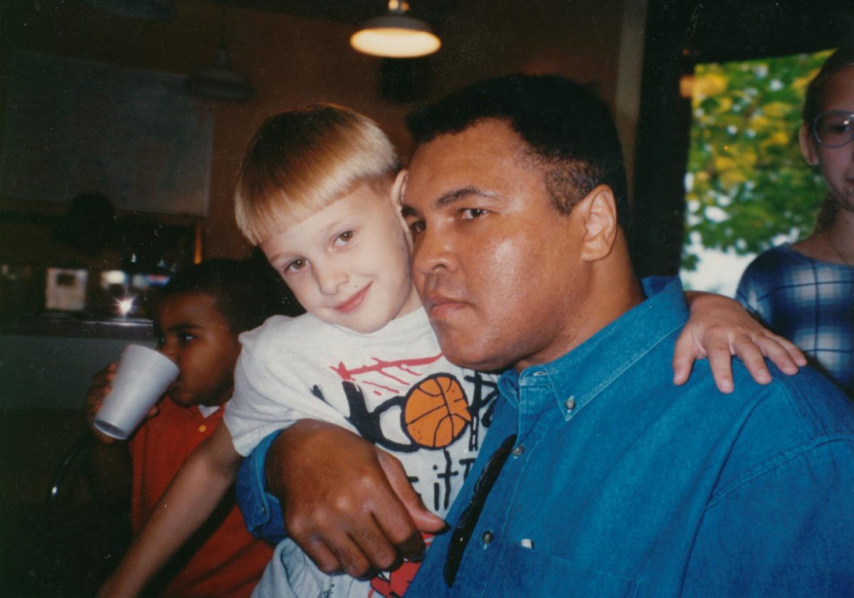 Muhammad Ali with Davis Miller as a young child. Photo courtesy Davis Miller from his book 'Approaching Ali'