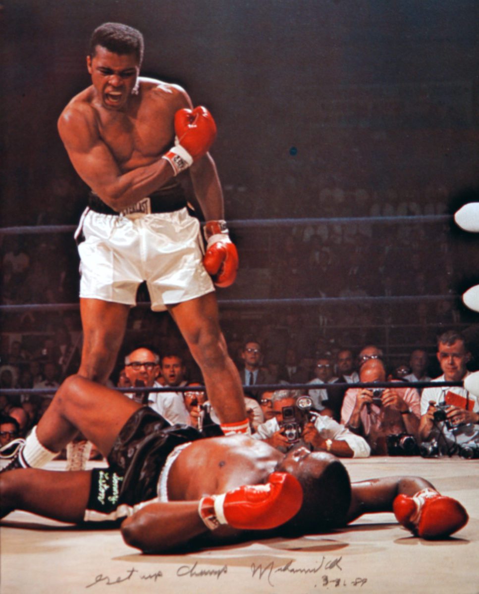Muhammad Ali standing over boxer, signed "Get Up Chump." Photo courtesy Davis Miller from his book 'Approaching Ali'