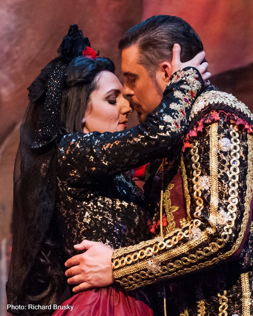 Carmen and Toreador in traditional Spanish wear in a passionate embrace.