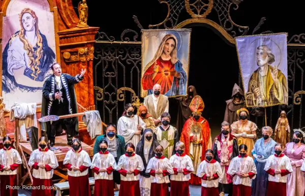 The cast of Opera Las Vegas's "Tosca" gathers on stage in front of a large golden gate and religious paintings to sing the "Te Deum."