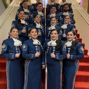 Mariachi Plata, posing in costume on a staircase.