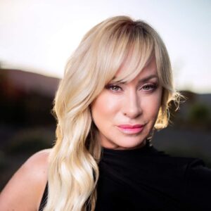 Monica Johns poses outside in a black top.